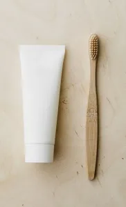 artistic positioning of toothpaste and toothbrush